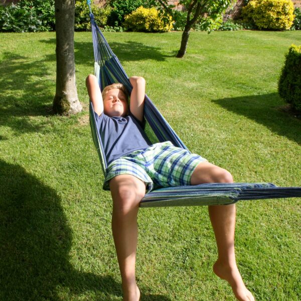 Boy asleep in hammock wearting Pyjama Shorts in brushed cotton green and navy check