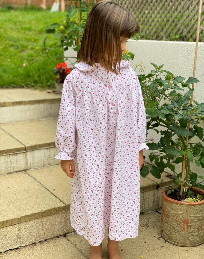 Liberty-inspired strawberry print brushed cotton nightdress worn by little girl on her patio