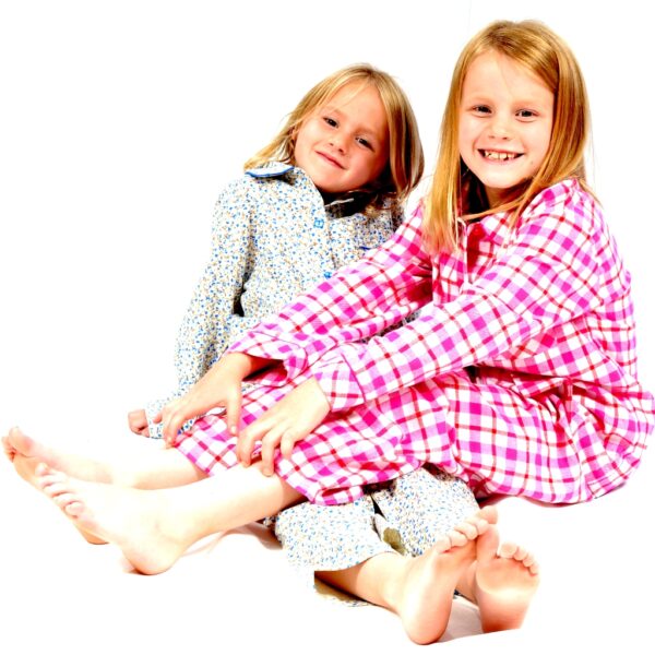 Girls in warm brushed cotton girls pyjamas for winter sitting on the floor