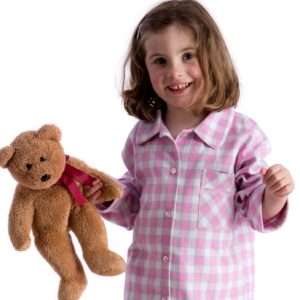 Pale pink, white and blue girls pyjamas on child holding teddy