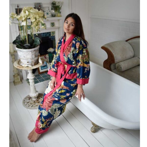 Lady leaning against bath in deep blue and pink dressing gown